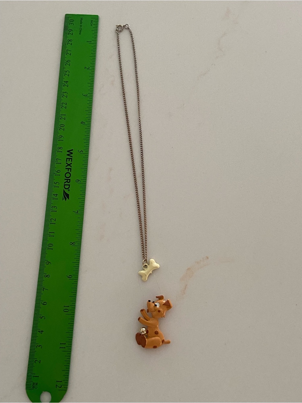 C. Wonder puppy pendant necklace features a dog-shaped charm on gold-tone chain